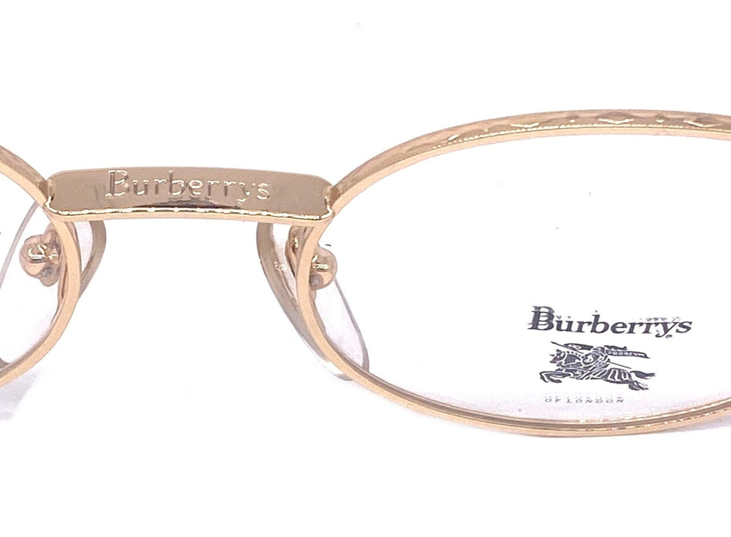 Burberrys B56-01 montature per occhiali ovali metalliche dorate moderniste vintage con classico tartan sulle aste, NOS anni '90 Francia