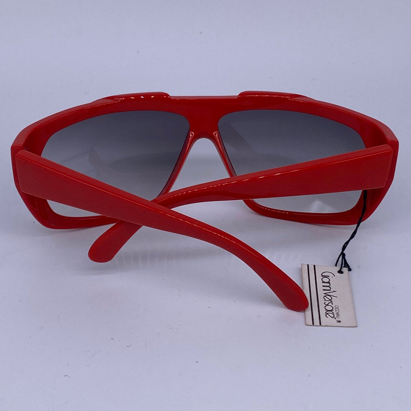 Gianni Versace red wrap modernist sunglasses with geometrical carvings, Italy 1980s NOS