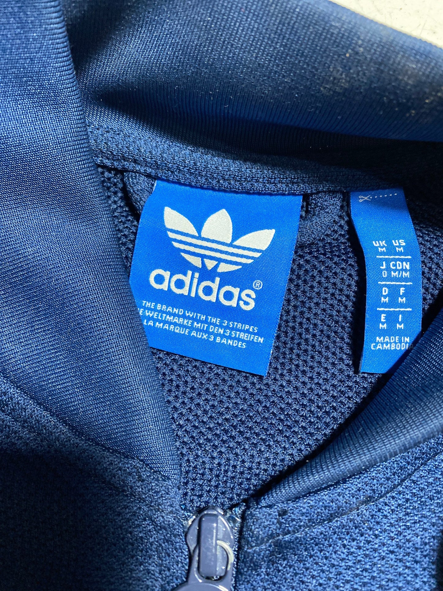 Adidas 90s navy deep blue tracktop jacket with white pocket strips and chest logo, perforated jersey fabric, minty