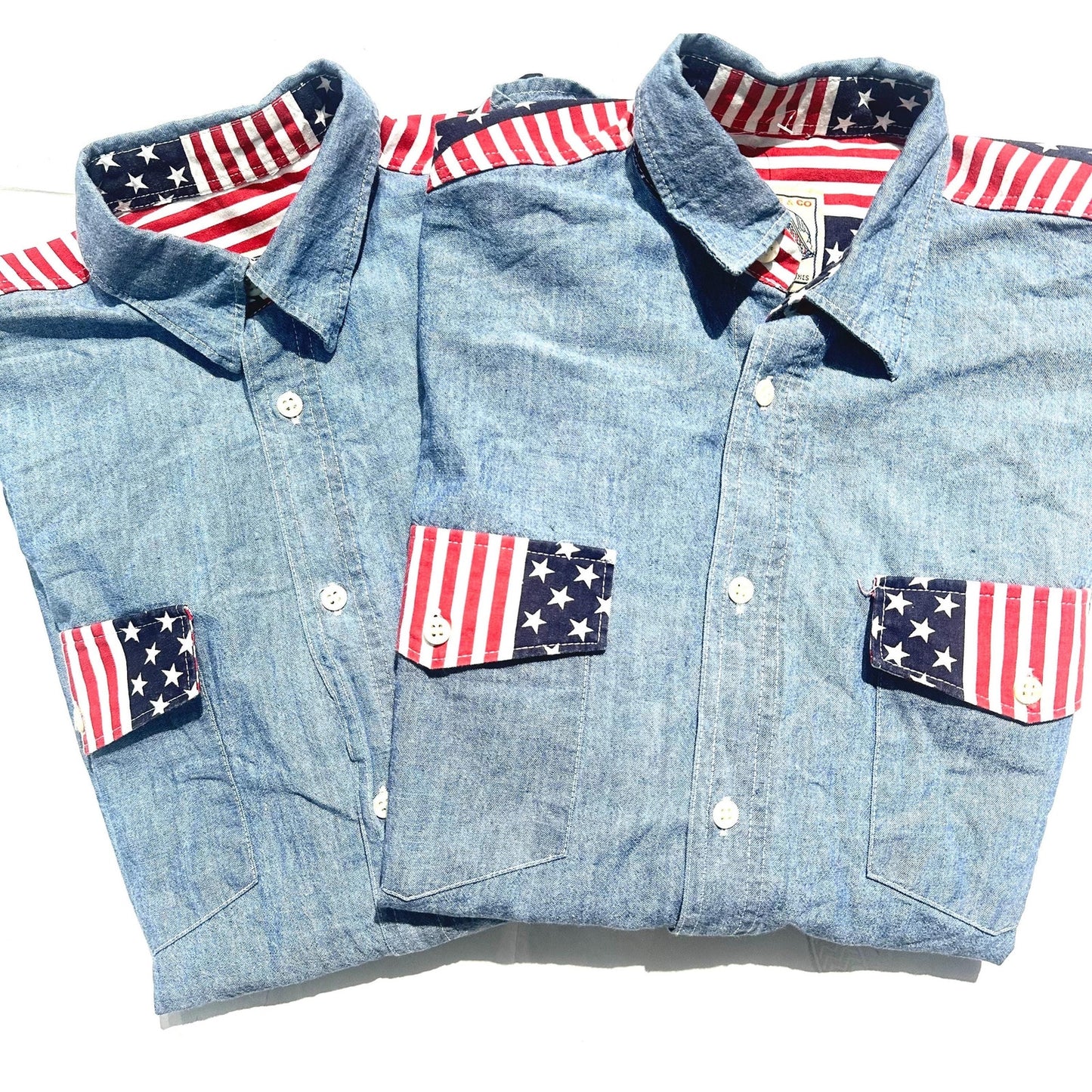 Biscote & Co denim shirt w US flag inserts at the collar, shoulders and cuffs, NoS 80s 2 pcs available.