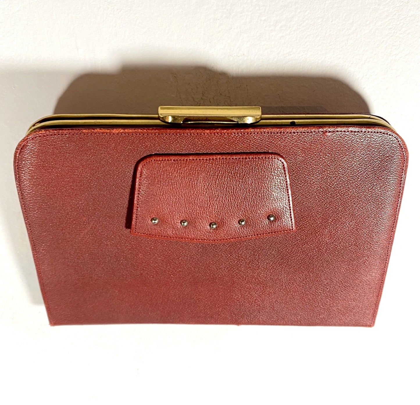 1960s burgundy leather and brass collectible clutch bag in mint condition