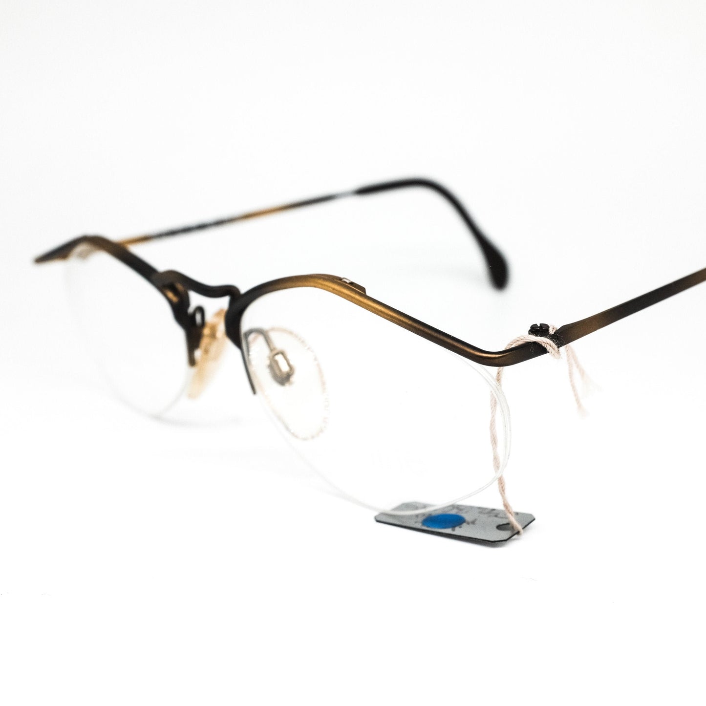 YABI-spirit minimal matt gold metallic eyeglasses frames in rimless design with pointing browline, 1980s NOS Germany.