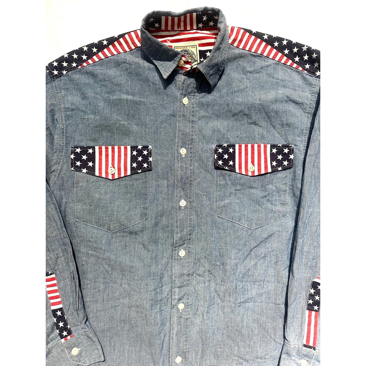 Biscote & Co denim shirt w US flag inserts at the collar, shoulders and cuffs, NoS 80s 2 pcs available.