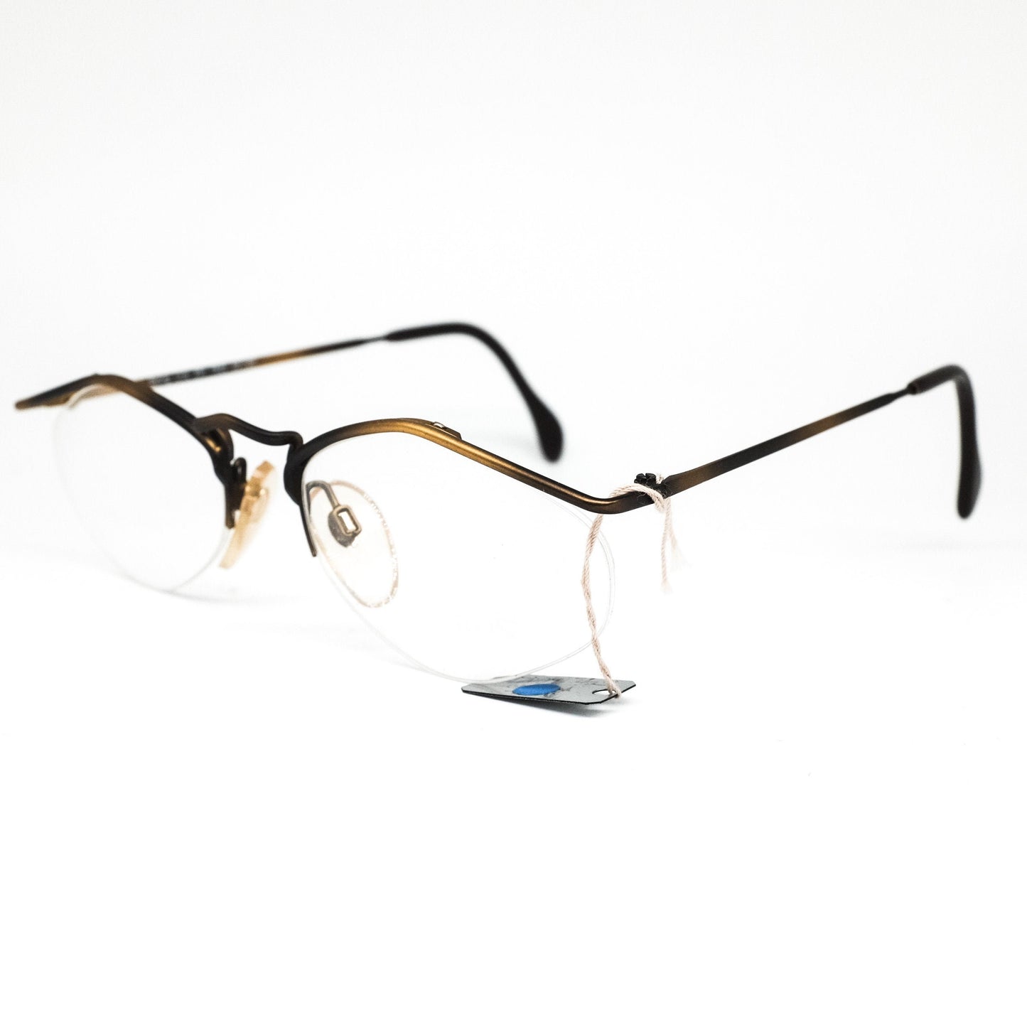 YABI-spirit minimal matt gold metallic eyeglasses frames in rimless design with pointing browline, 1980s NOS Germany.