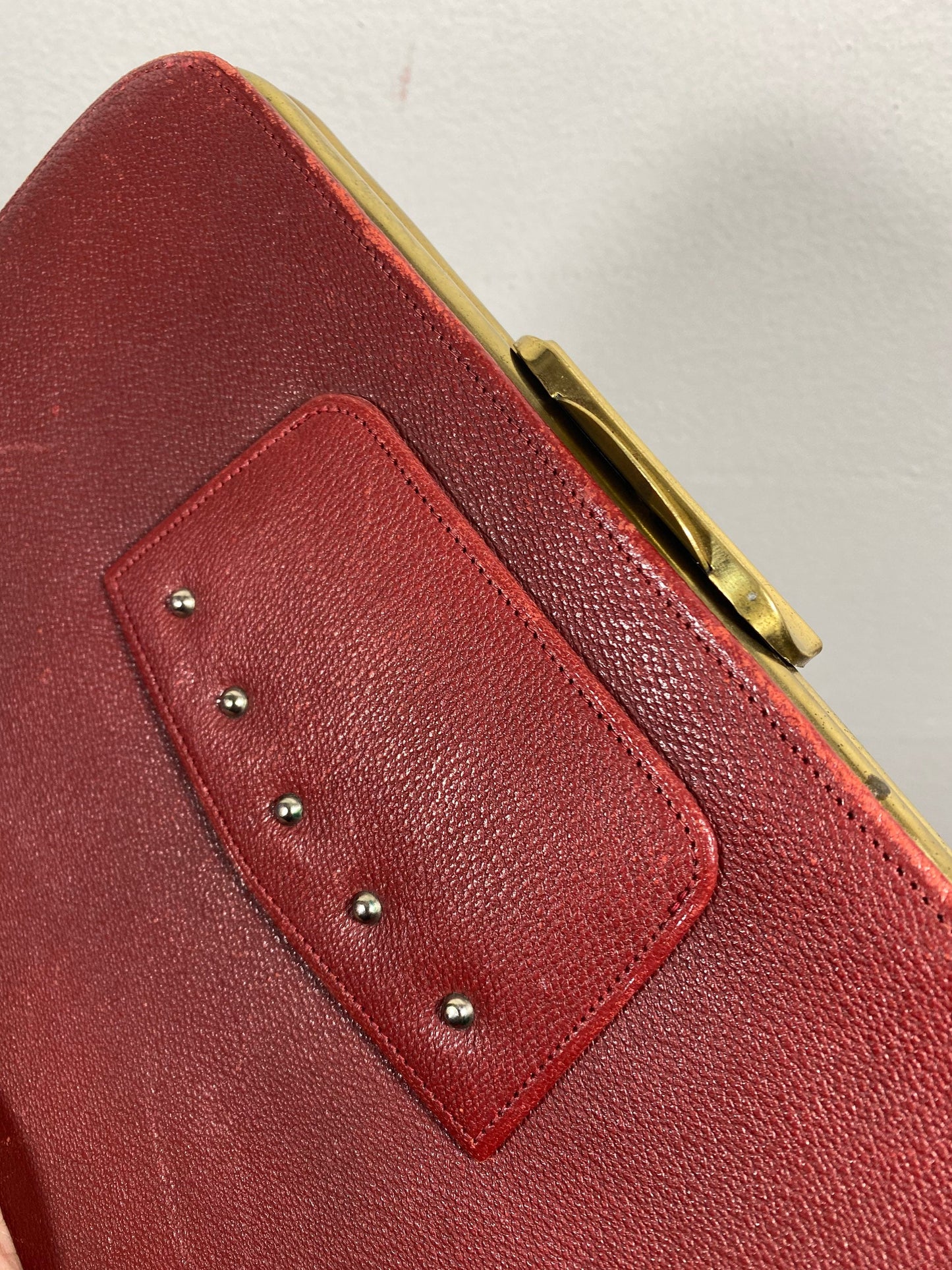 1960s burgundy leather and brass collectible clutch bag in mint condition