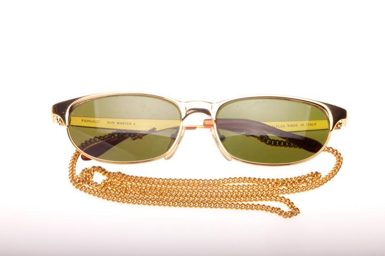 Fiorucci hip golden Cateye with pierced temples and enclosed chain, NOS 80s Italy